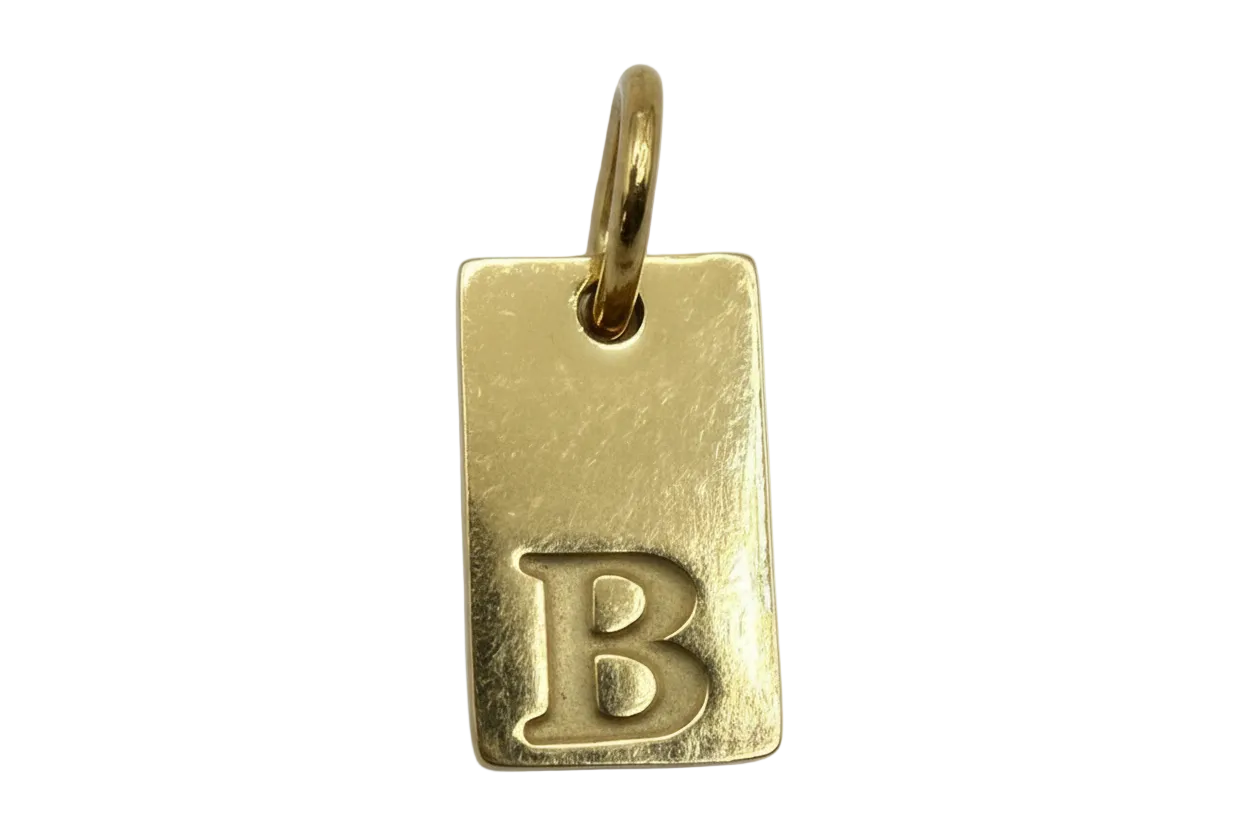 Gold rectangular initial tag with raised letter B and textured finish