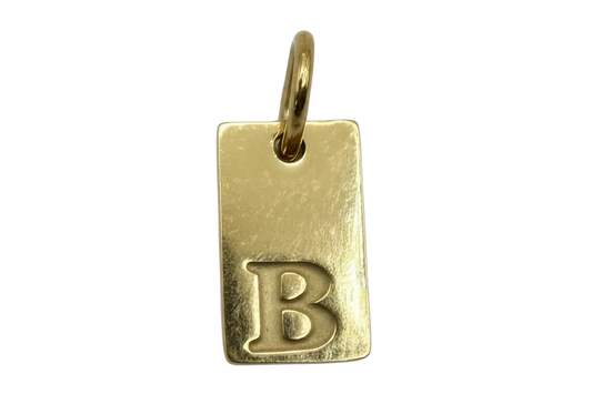 Gold rectangular initial tag with raised letter B and textured finish