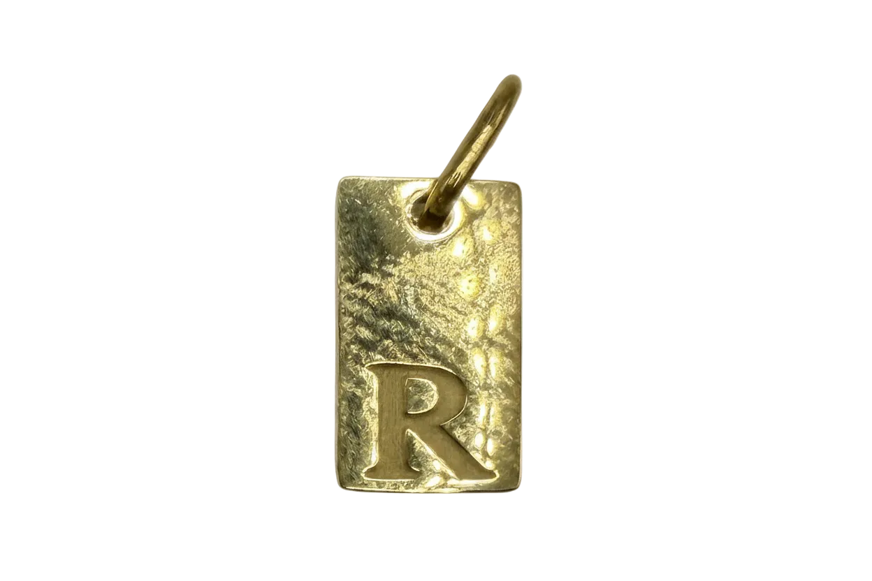Gold rectangle tag with hammered texture and raised letter R