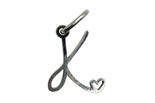 Polished silver script letter K with heart cutout accent