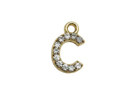 Gold letter C initial with pavé clear crystals on a black background