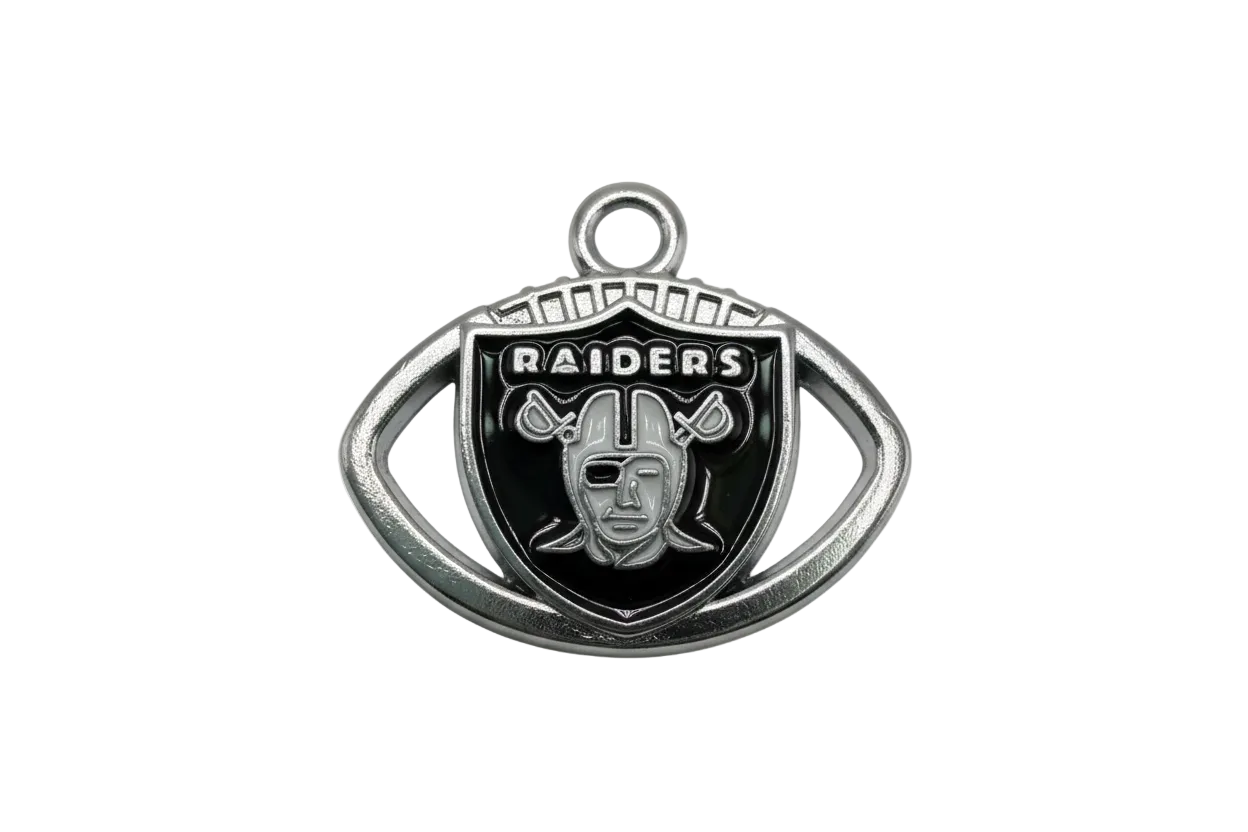 Silver-tone shield emblem with glossy black enamel and raised football helmet motif