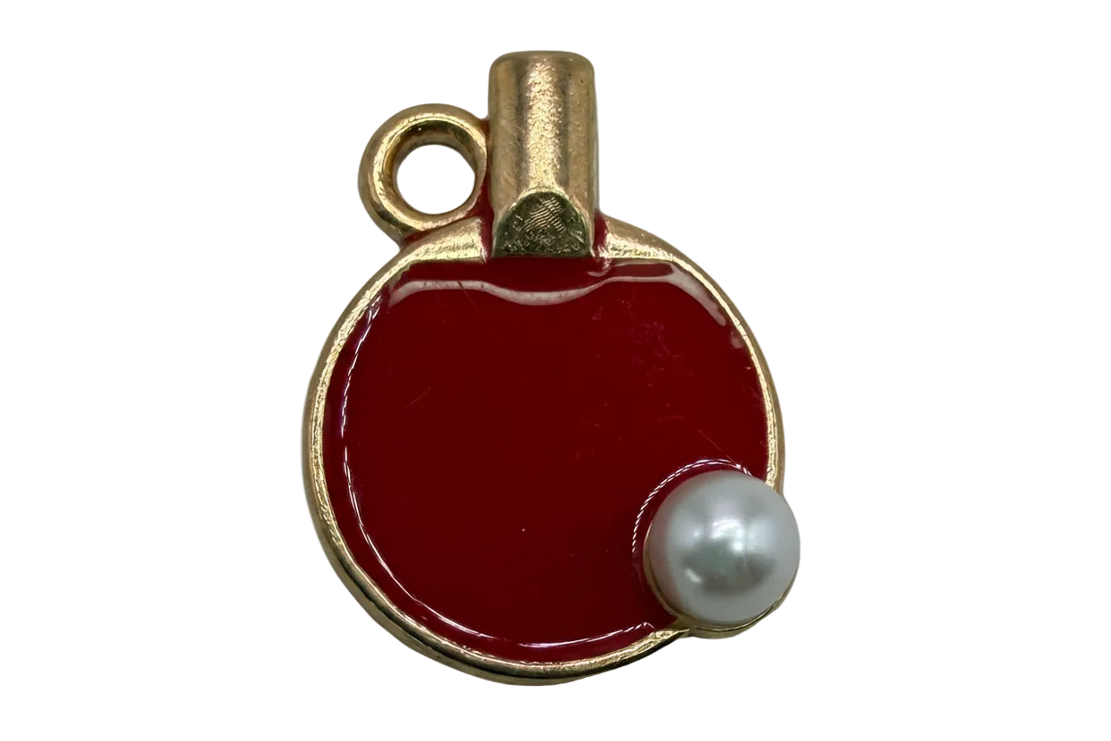Glossy red enamel round flask charm with gold trim and black-and-white stopper detail