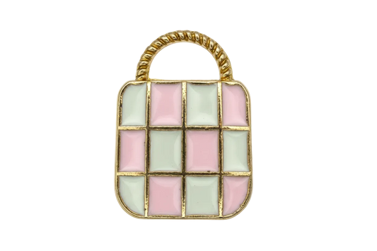 Gold-outlined handbag motif with pastel pink and mint checkered enamel and a light gray handle pattern