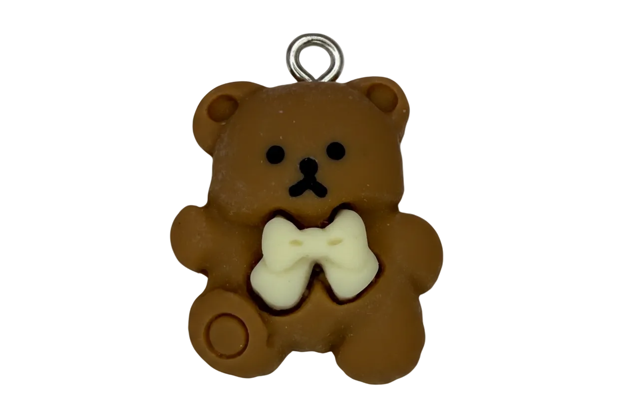Brown teddy bear charm with ivory bow and black face details, silver top