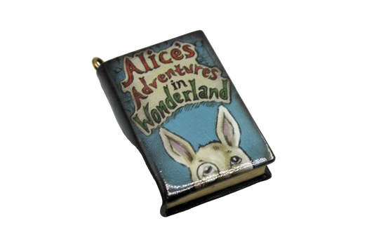 Vintage-style rabbit storybook cover charm with multicolor lettering on a blue background, gold finish
