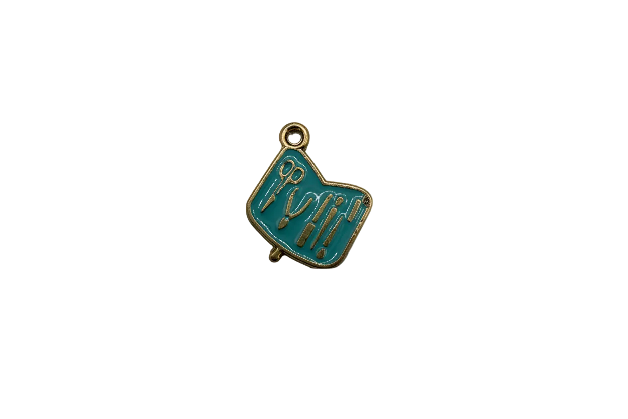 Teal enamel art tools plaque with gold raised details