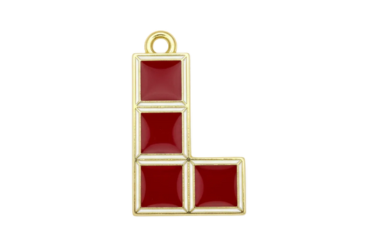 Glossy red enamel block puzzle piece in an L-shape with gold outline