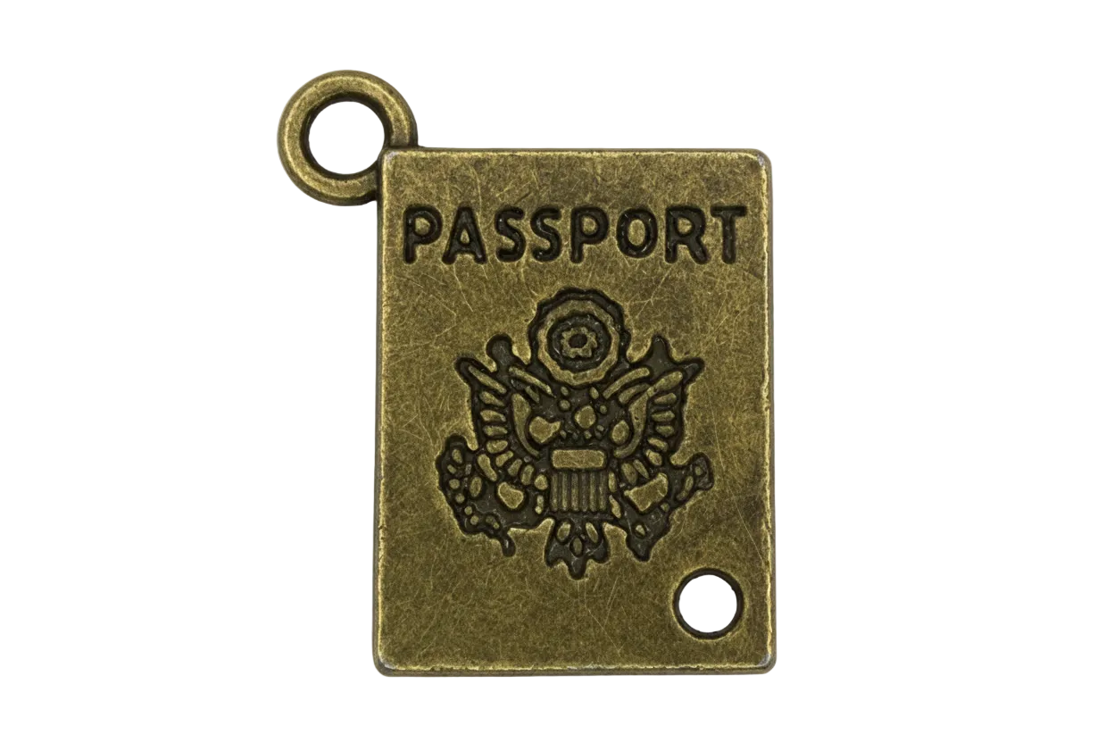 Antique gold miniature passport book charm with engraved "PASSPORT" lettering and crest