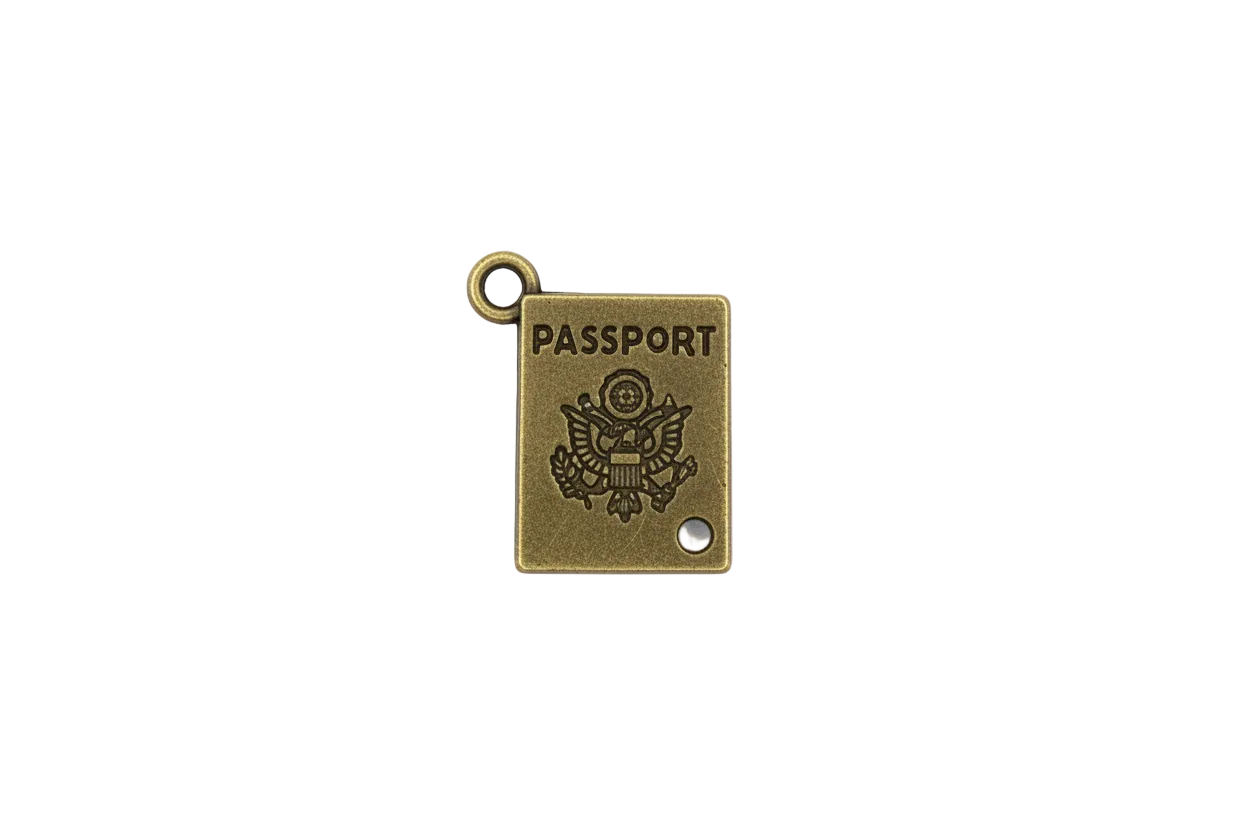 Antique gold passport book charm with engraved lettering and crest