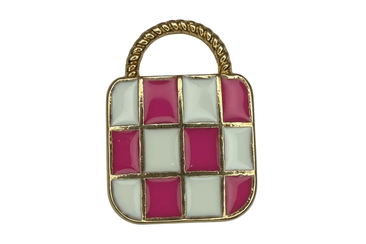 Pink and white checkerboard handbag charm with gold trim and a textured pale gray handle panel