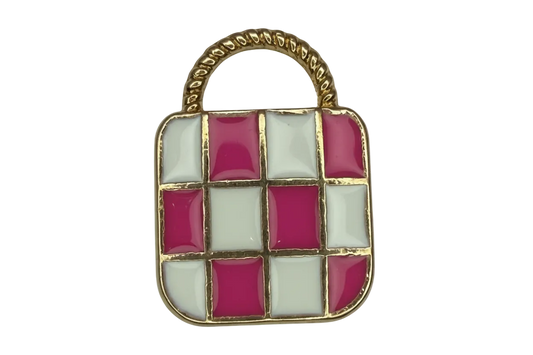 Pink and white checkerboard handbag charm with gold trim and a textured pale gray handle panel