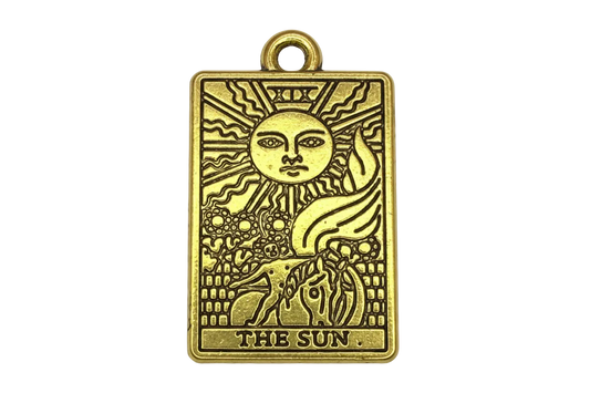 Antiqued gold rectangular sun tarot card with engraved face, rays, horse, and “THE SUN” text