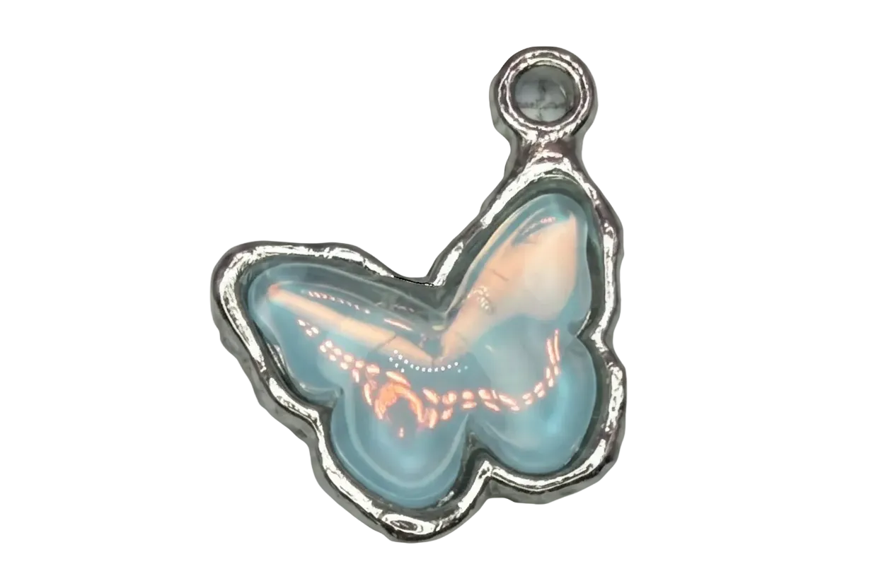 Opalescent light blue butterfly cabochon with iridescent sheen in polished silver-tone frame