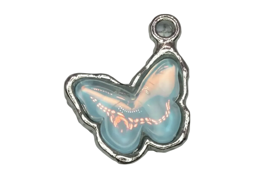 Opalescent light blue butterfly cabochon with iridescent sheen in polished silver-tone frame
