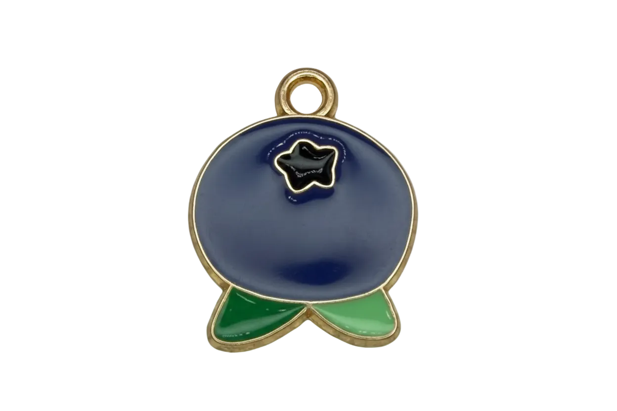 Navy blue enamel whale with green tail accents and gold outline