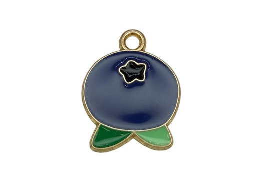 Navy blue enamel whale with green tail accents and gold outline