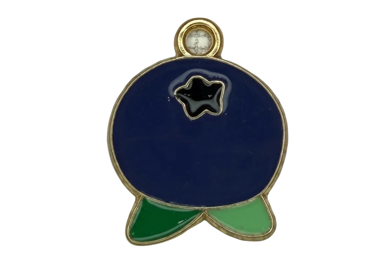Gold-outlined navy enamel fish with black star detail and green fins