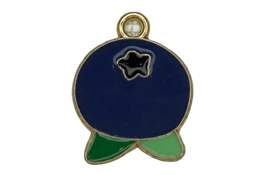 Gold-outlined navy enamel fish with black star detail and green fins