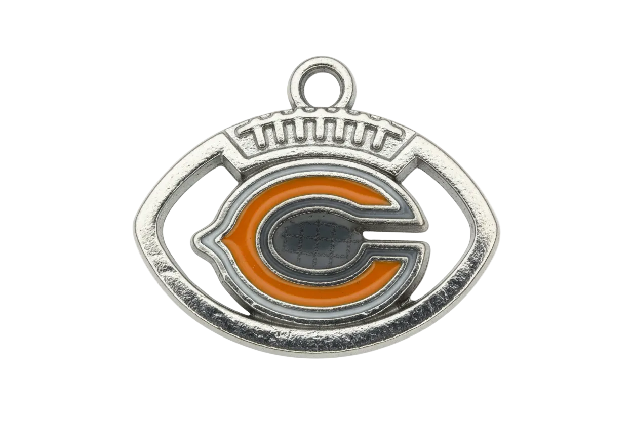 Silver football-shaped emblem with orange letter detail and glossy enamel accents