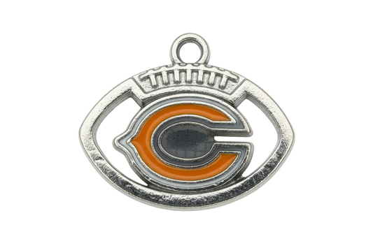 Silver football-shaped emblem with orange letter detail and glossy enamel accents