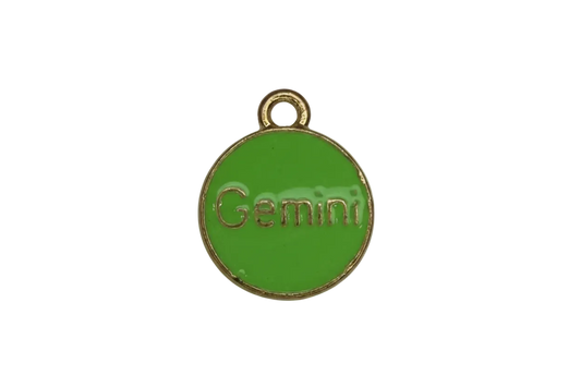 Glossy green enamel round disc with gold rim and raised Gemini lettering