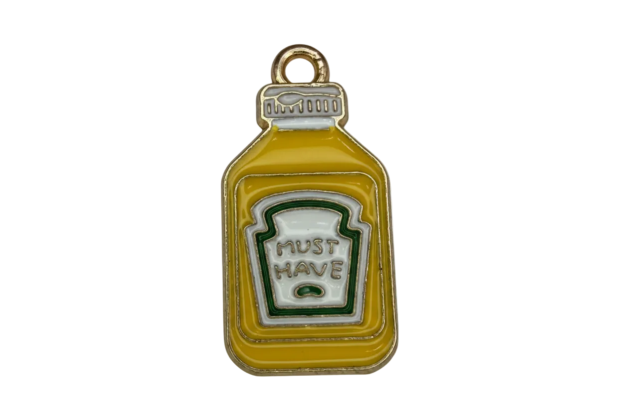 Mustard-yellow sauce bottle charm with white label and green outline in gold-tone metal
