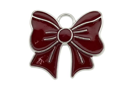 Glossy burgundy enamel bow with silver-toned outline and ribbon detailing