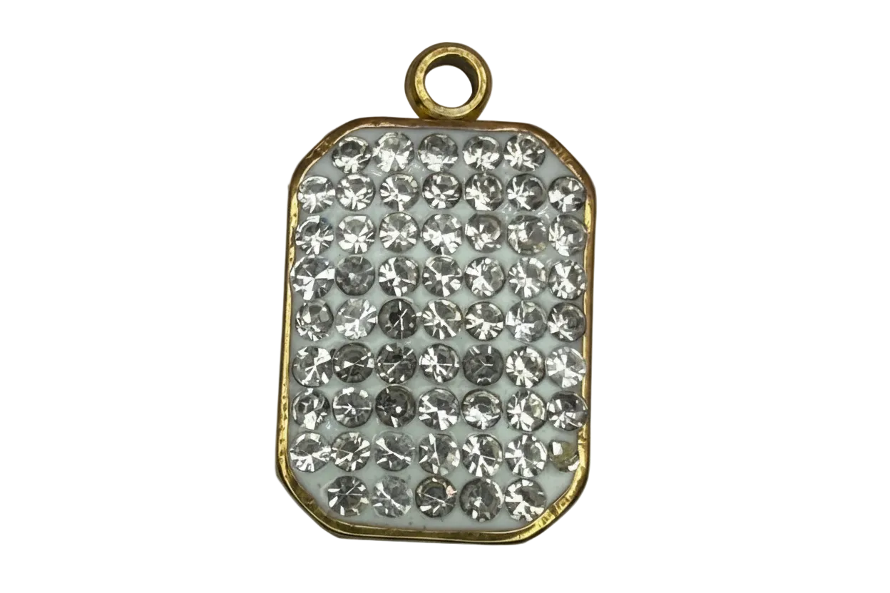 Gold-edged rounded rectangle plaque with pavé clear crystals on a white base
