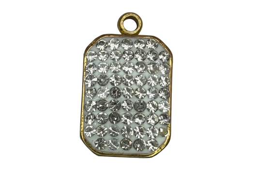 Gold-edged rounded rectangle plaque with pavé clear crystals on a white base
