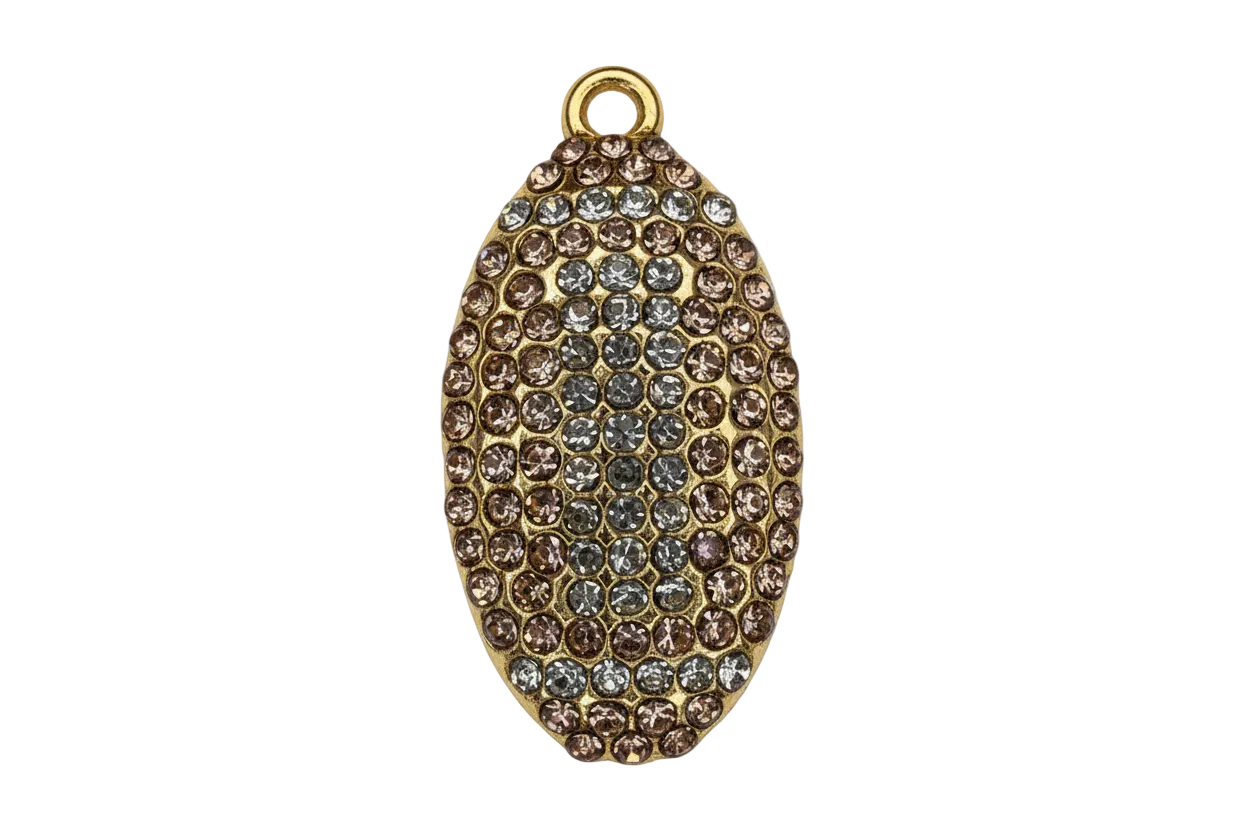 Gold oval pavé piece with champagne and clear crystals in a raised, textured pattern