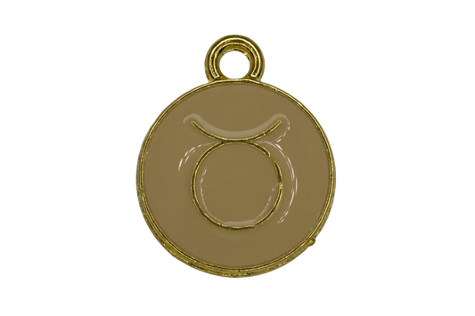 Round beige enamel Taurus zodiac medallion with raised gold symbol