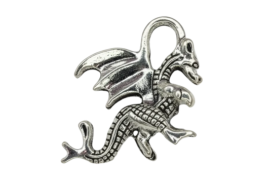 Silver winged dragon charm with textured scales, raised wings, and curled tail