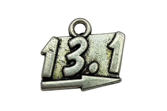 Antiqued silver 13.1 race distance plaque with raised numbers and arrow