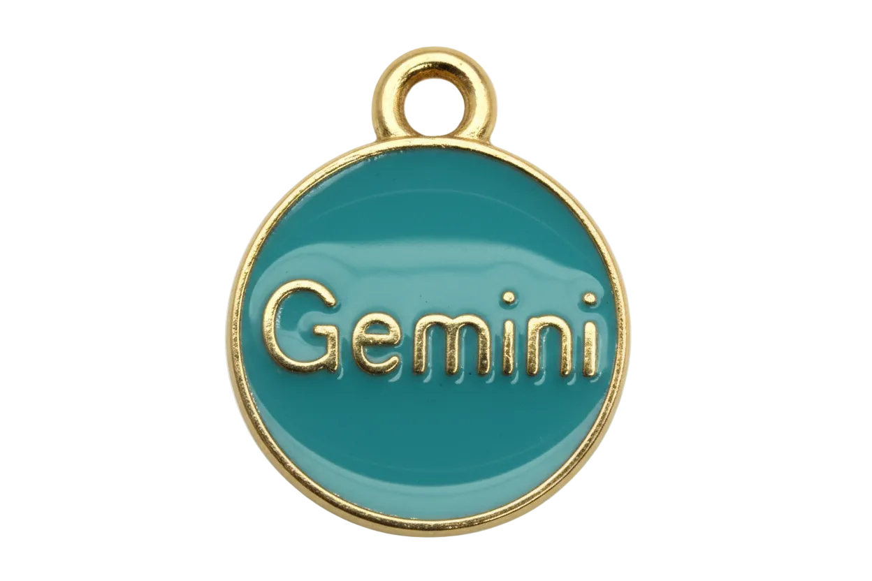 Glossy teal round Gemini medallion with raised gold lettering and gold rim