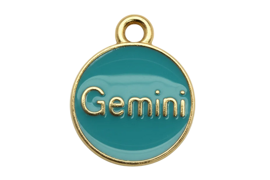 Glossy teal round Gemini medallion with raised gold lettering and gold rim