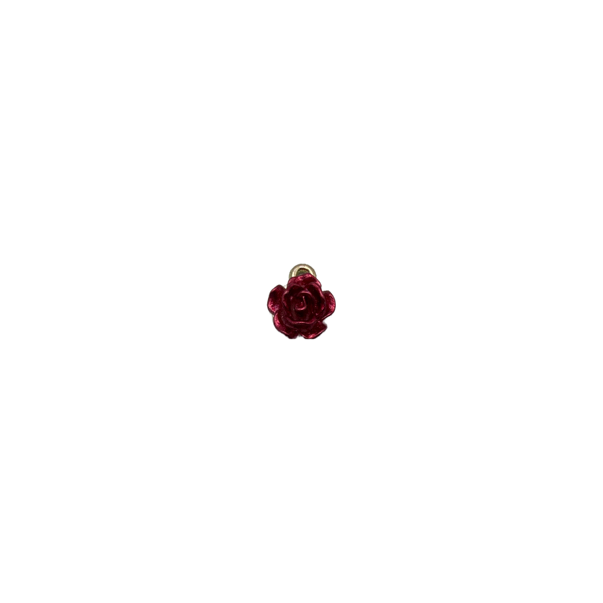 Glossy burgundy rose bloom with gold-toned top