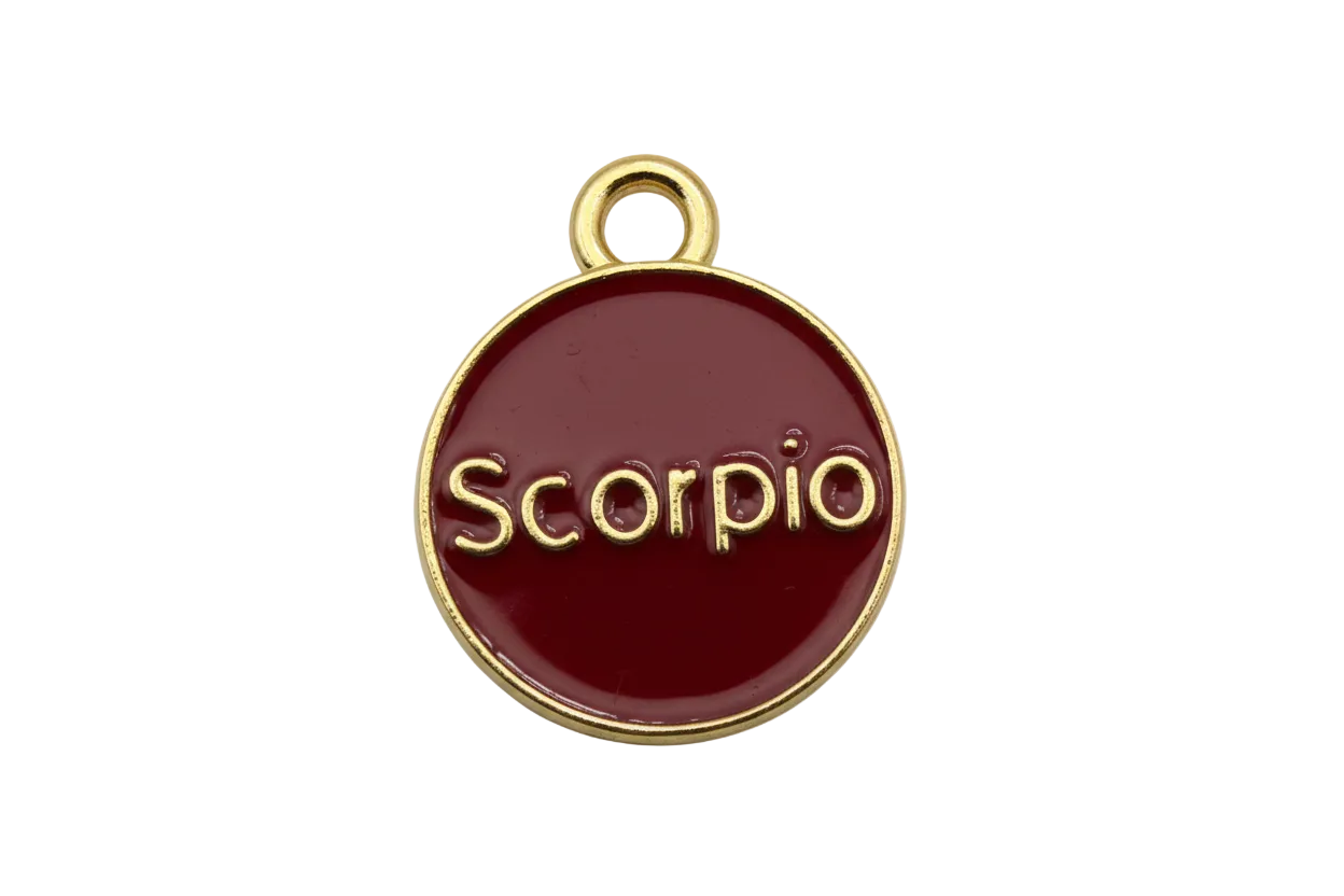 Glossy crimson enamel Scorpio zodiac disc with raised gold lettering and gold rim