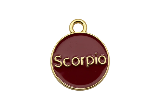 Glossy crimson enamel Scorpio zodiac disc with raised gold lettering and gold rim