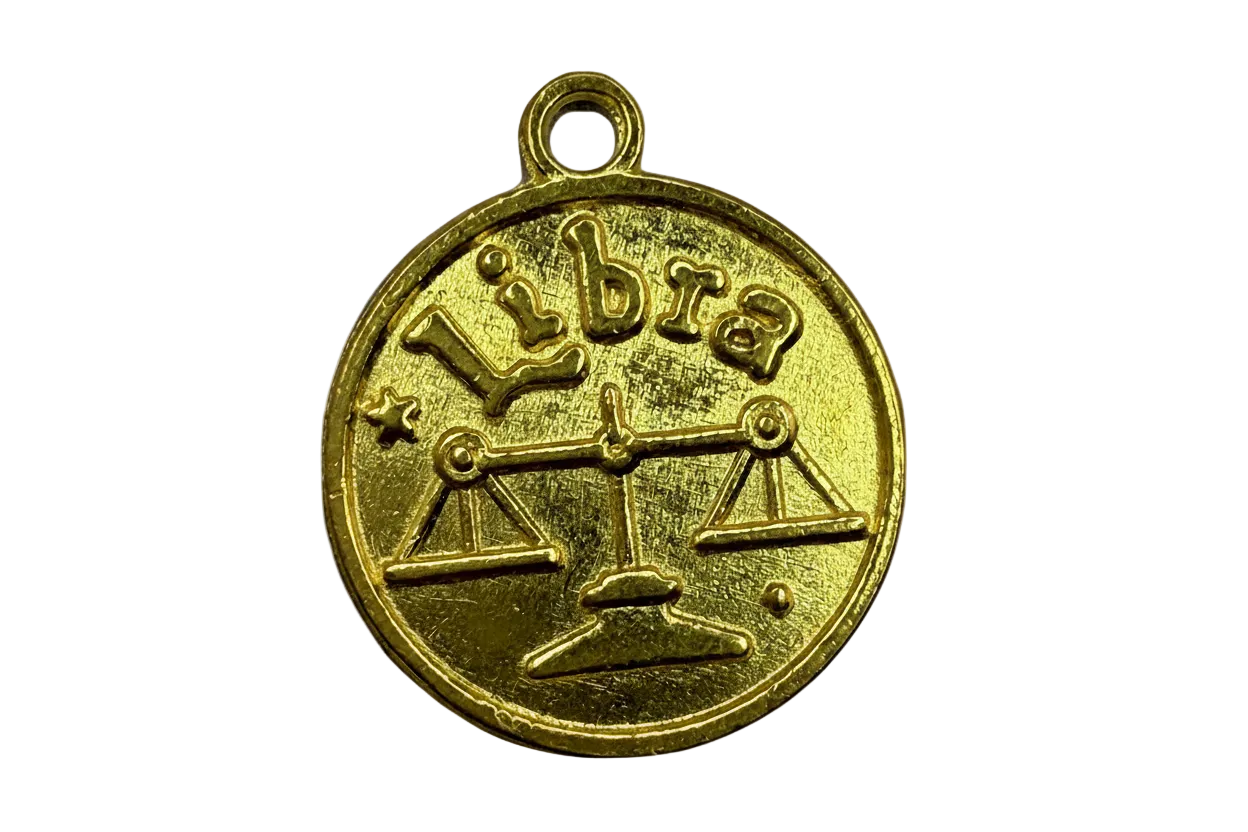 Round gold Libra coin with embossed scales symbol and raised lettering