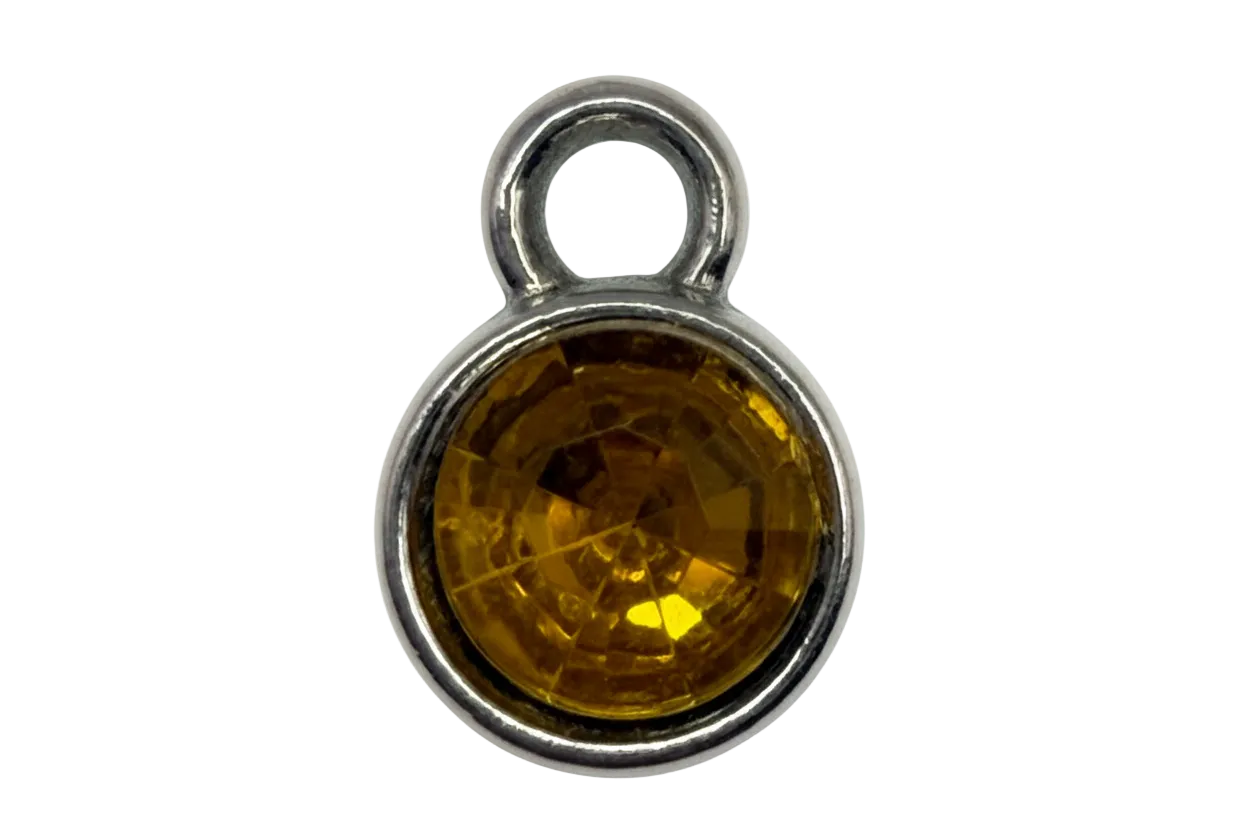 Round faceted amber-yellow gem in a polished silver frame