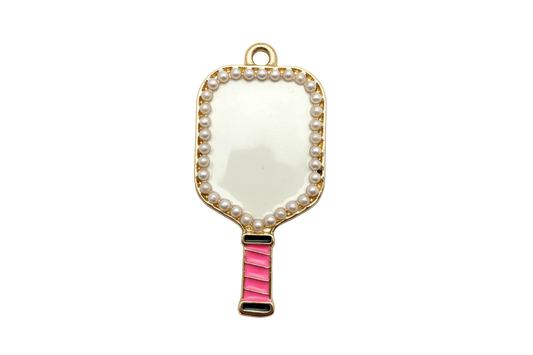 Gold hand mirror charm with pearl-like border, creamy white face, and bright pink handle