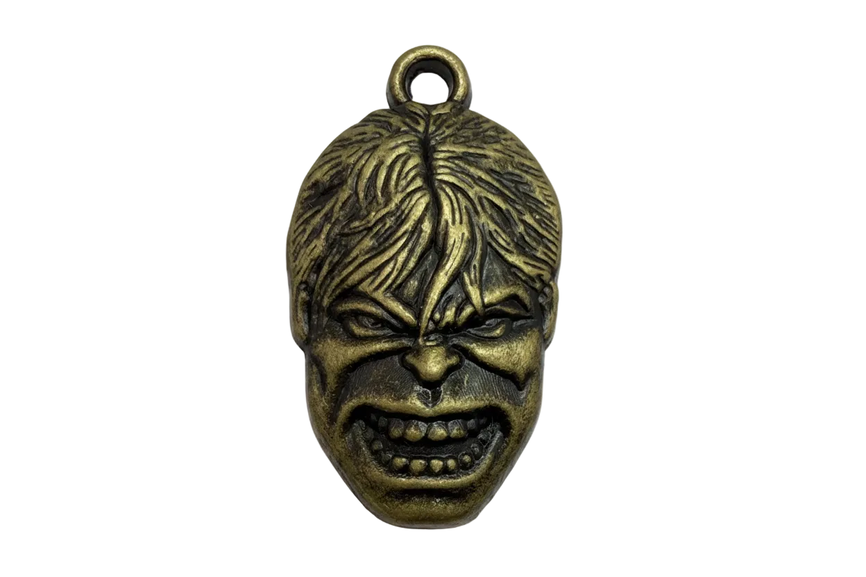 Antiqued gold snarling face mask charm with carved hair and shadowed details