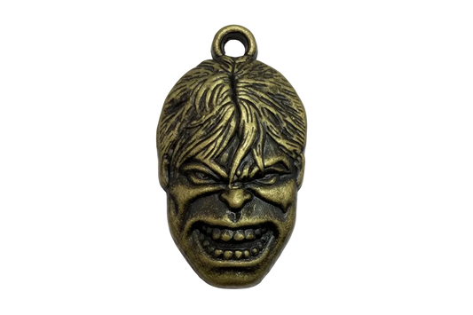 Antiqued gold snarling face mask charm with carved hair and shadowed details
