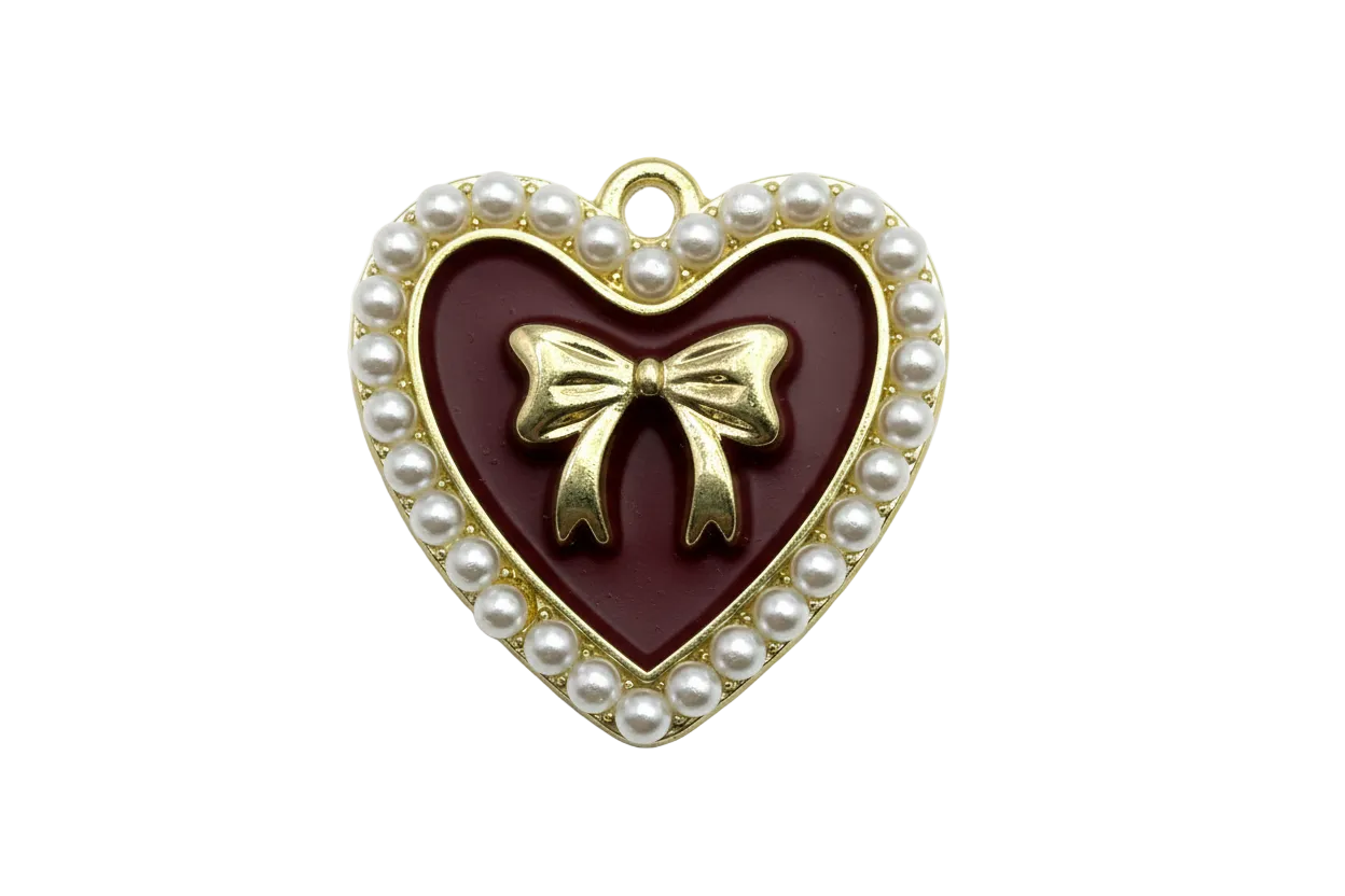 Gold heart charm with burgundy enamel center, raised bow, and pearl-trim border