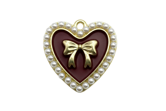 Gold heart charm with burgundy enamel center, raised bow, and pearl-trim border