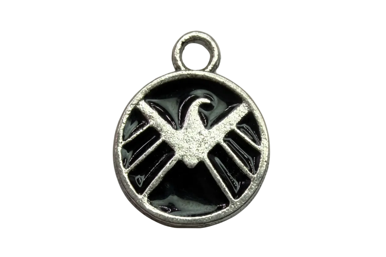 Round silver medallion with raised eagle insignia over glossy black enamel