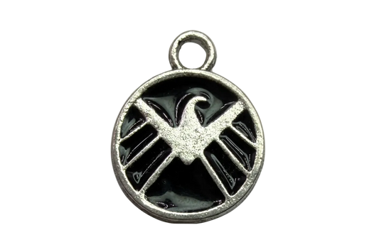 Round silver medallion with raised eagle insignia over glossy black enamel