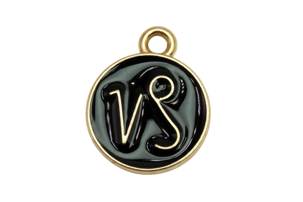 Round black enamel disc with gold border and VS script initials