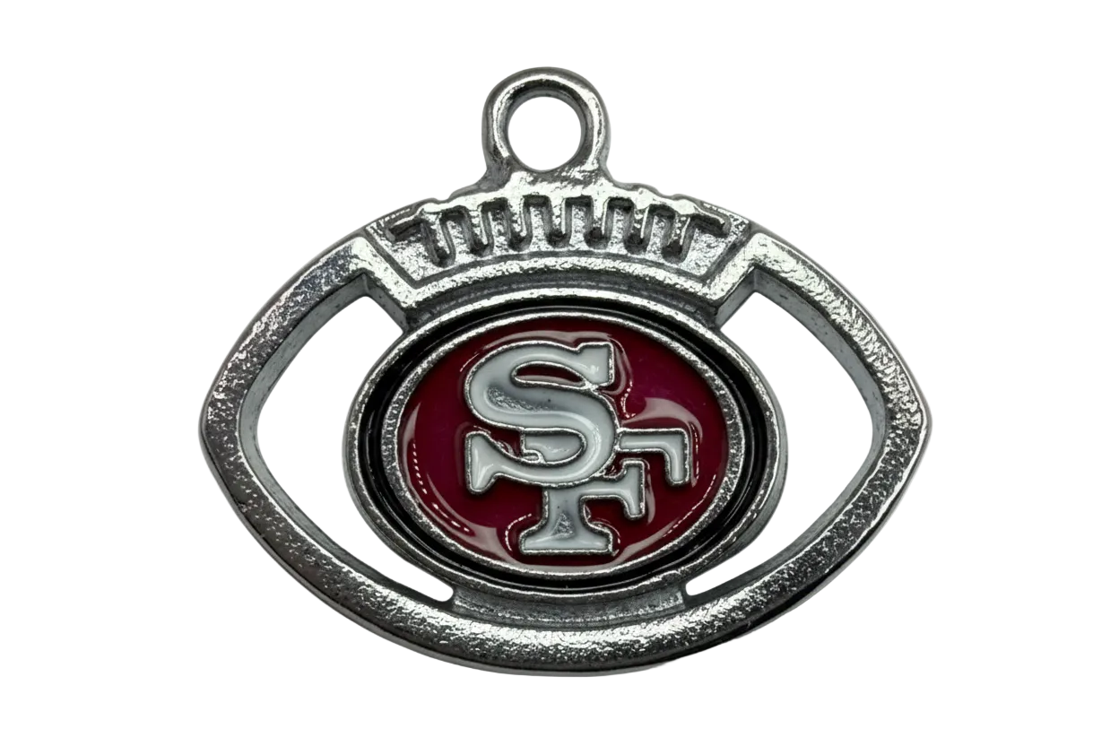 Silver football-shaped emblem with red enamel center and raised monogram detail